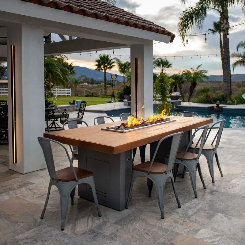 The Outdoor Plus Alameda fire table wooden top patio and pool.