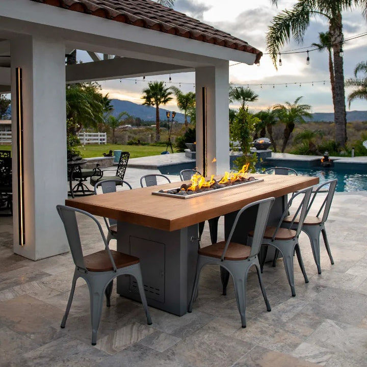 The Outdoor Plus Alameda fire table wooden top patio and pool.
