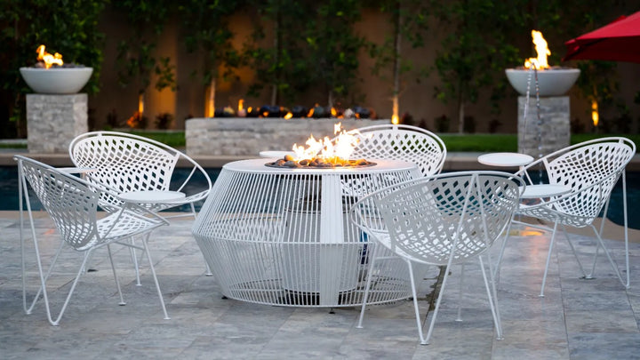 The Outdoor Plus Cesto fire pit white powder coat with matching patio chairs