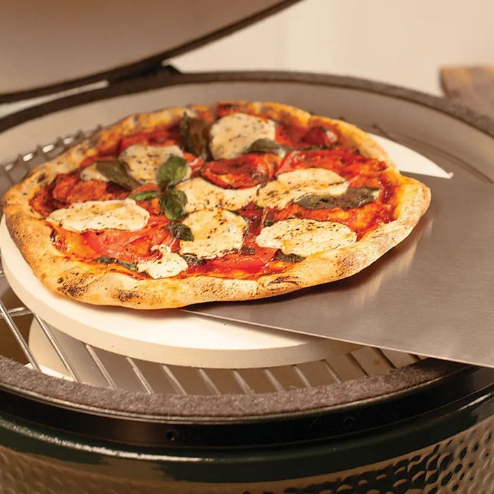 Big Green Egg pizza on metal peel stone