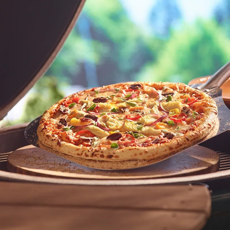 Big Green Egg pizza stone with a slice
