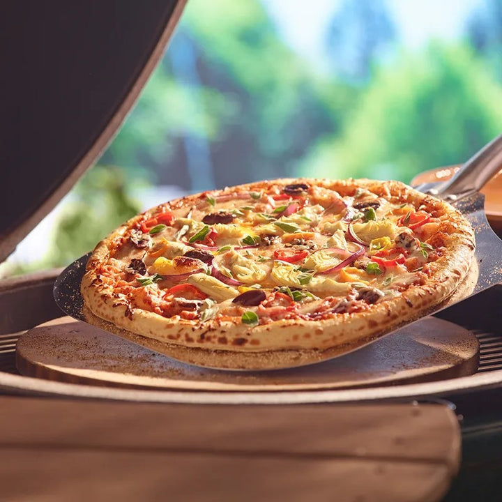 Big Green Egg pizza stone with a slice