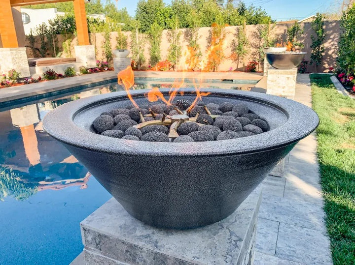 Cazo fire bowl silver vein powder coated finish 24 inch diameter and bullet burners pool side.