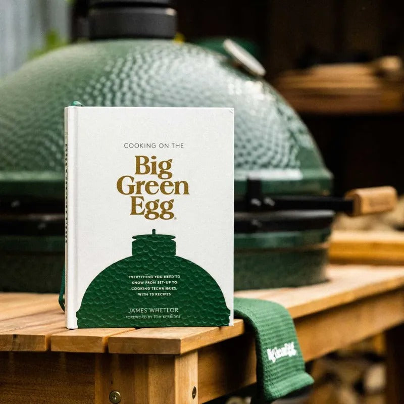 Cooking on the  Big Green Egg cookbook manual on table