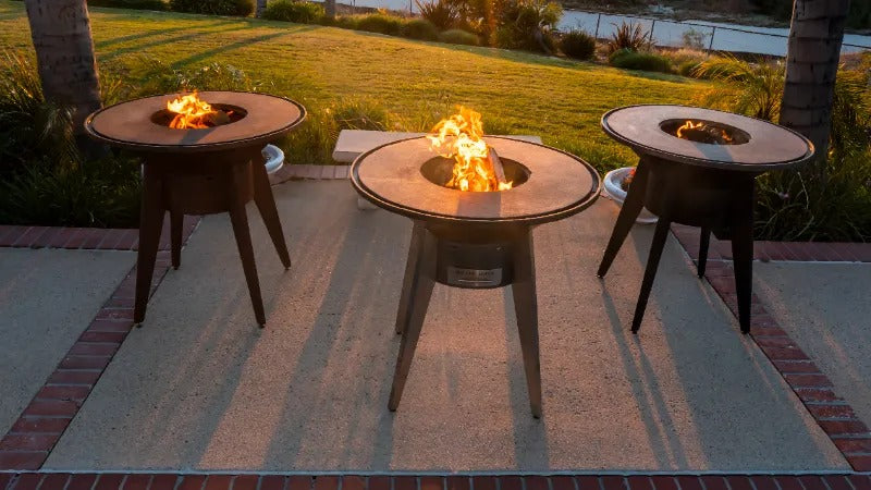 3 Mojave Grills at sunset under the palm trees - powder coated black, stainless steel and corten steel.