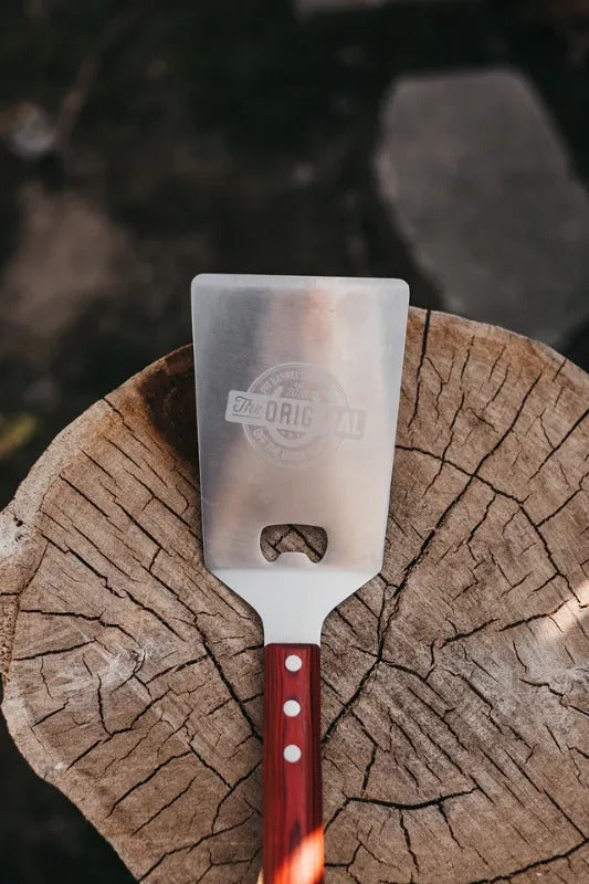 Pit Barrel Cooker Ultimate Spatula on stump