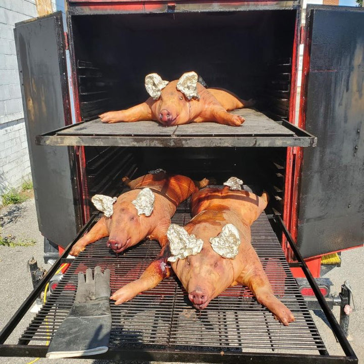 Smokin Brothers Commercial Big Red cooking pigs