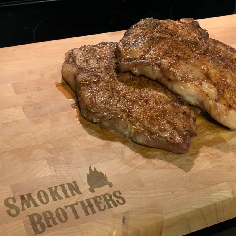 Smokin Brothers maple cutting board grilled steaks