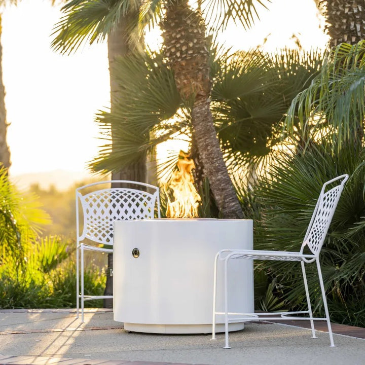The Outdoor Plus Beverly fire pit powder coated white under palms