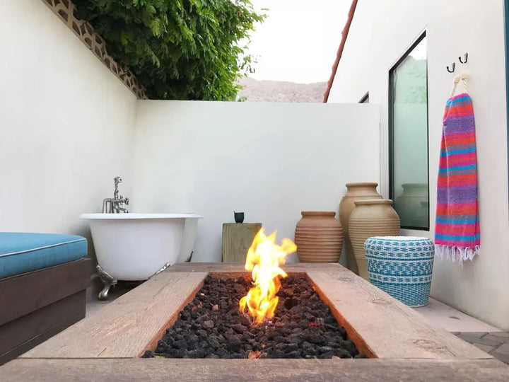 The Outdoor Plus Coronado fire pit oak wood grain in backyard