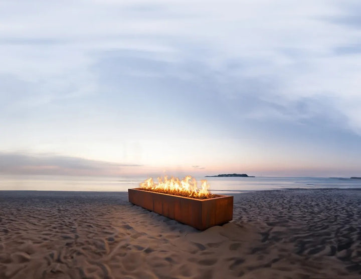 The Outdoor Plus Eaves Fire Pit Corten Steel on beach