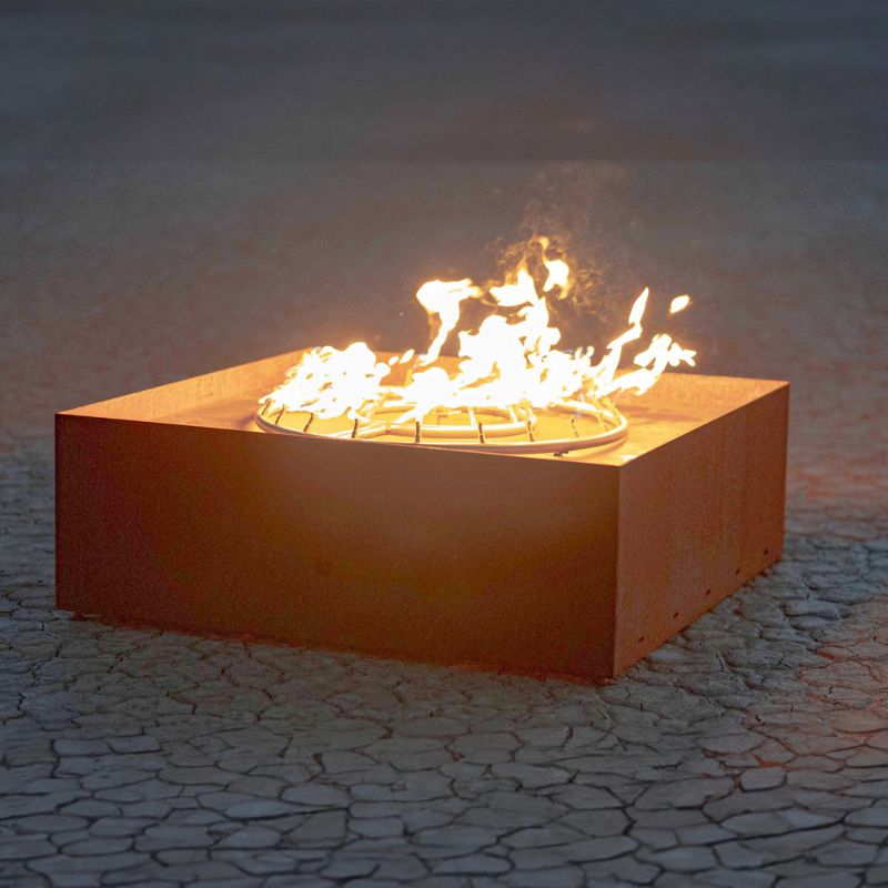 The Outdoor Plus Fire Pit Sculpture The Atomic flaming on a dry lake bed.