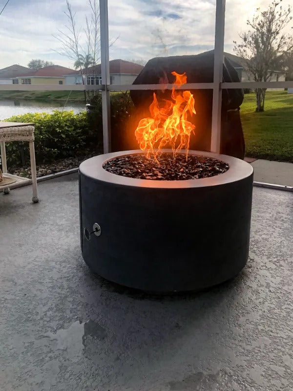 The Outdoor Plus Florence Concrete Black 32 inch Fire Pit in Backyard