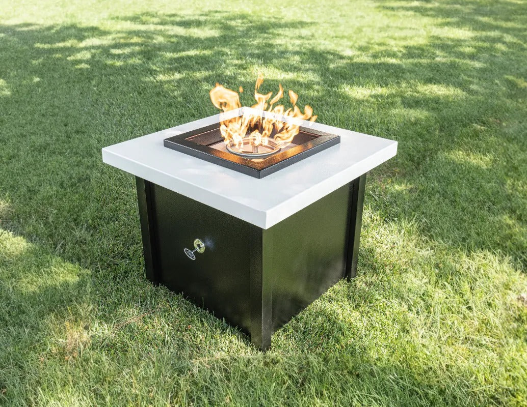 The Outdoor Plus Kamoa Fire Table on the lawn