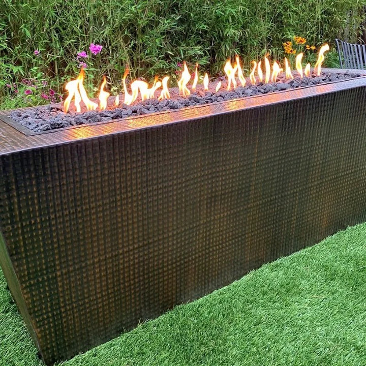 The Outdoor Plus Mesa fire pit hammered copper  60 inch on the grass