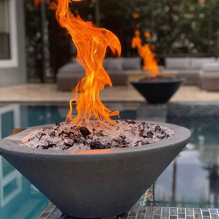 A Cazo fire bowl flaming high with bullet burners and mixed fire glass.